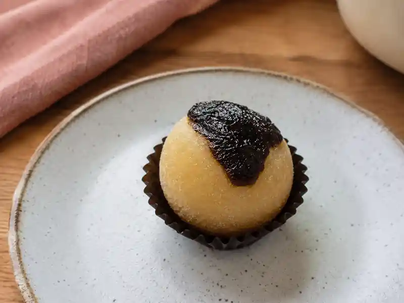 Olho de Sogra artesanal em forminha sobre prato de cerâmica — Casa do Brigadeiro